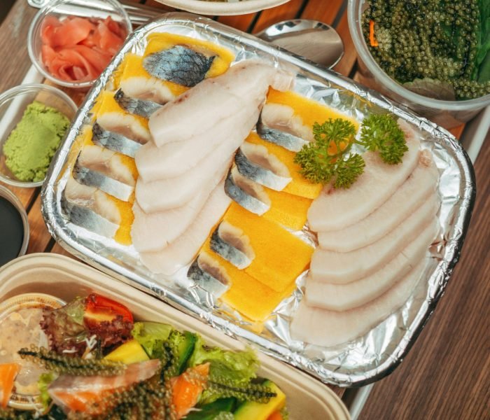 Delicious sashimi platter with fresh fish and condiments, perfect for sushi lovers.
